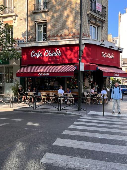 a restaurant with tables and chairs on a city street at Paris Home in Boulogne-Billancourt