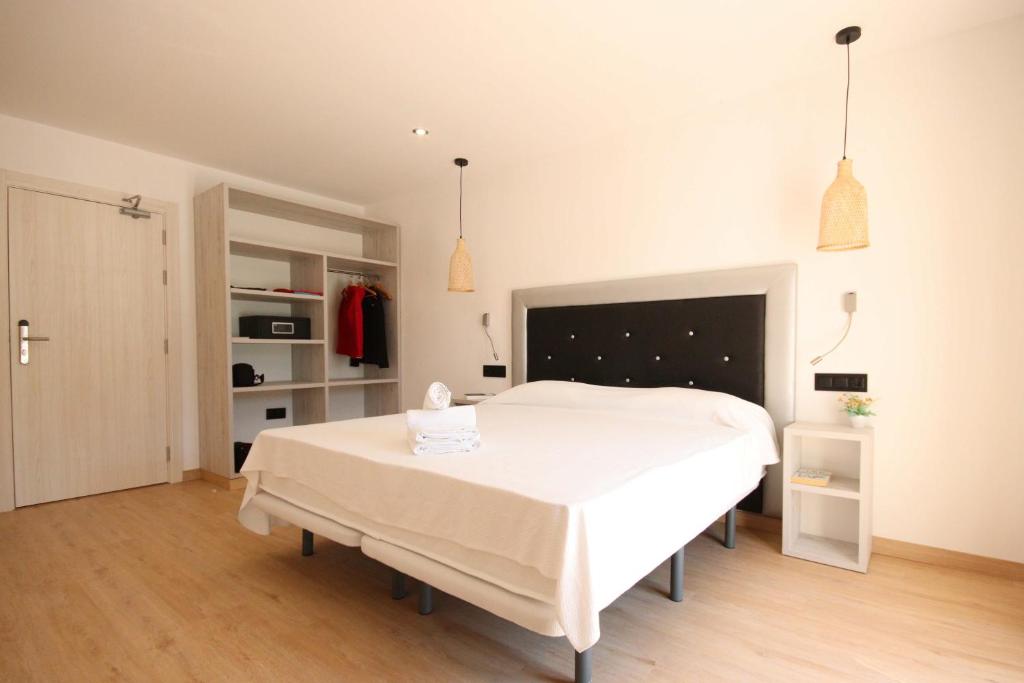 a bedroom with a large white bed in a room at Hotel Costa Brava in Roses