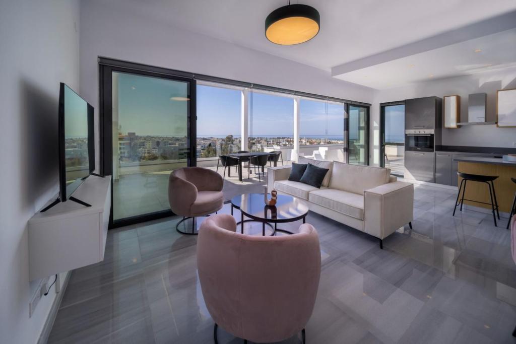a living room with a couch and a table at Premier 401 3 bedroom penthouse in Paphos City