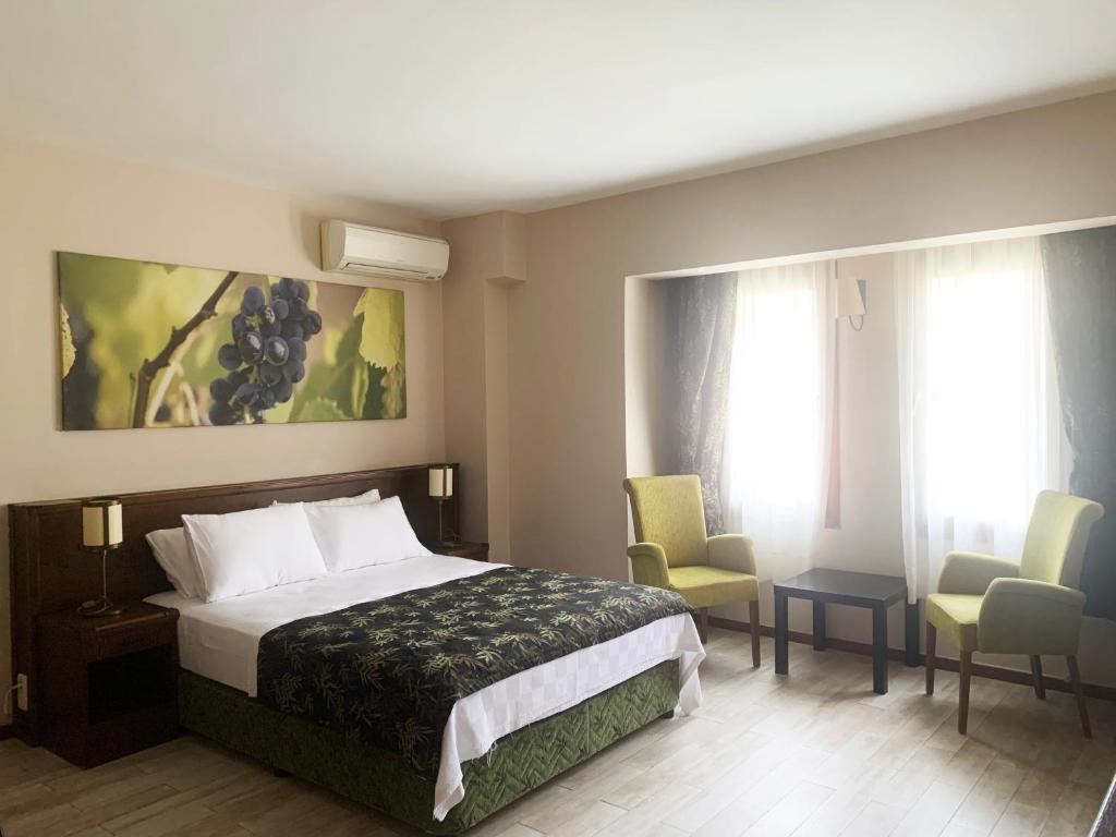 Postel nebo postele na pokoji v ubytování Mitos Hotel