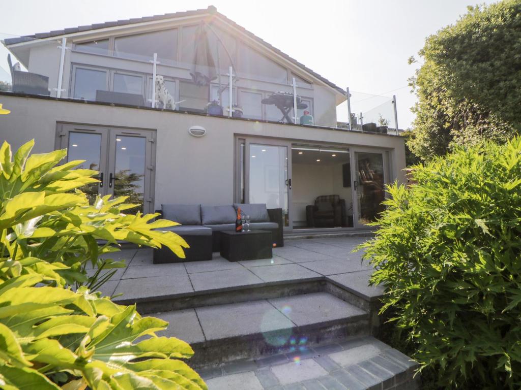 a house with a couch on a patio at Riverview 1 Brunel View in Saltash