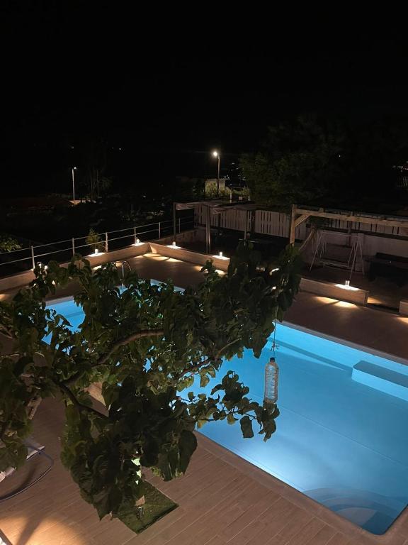 a swimming pool at night with lights on it at Magic View 4U Luxury Villa, Tago Vibes in Kineta