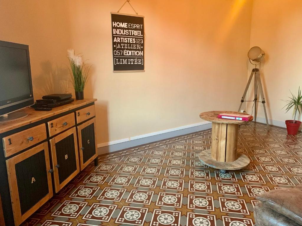 a living room with a tv and a table at La maisonnée de Chambord in Crouy-sur-Cosson