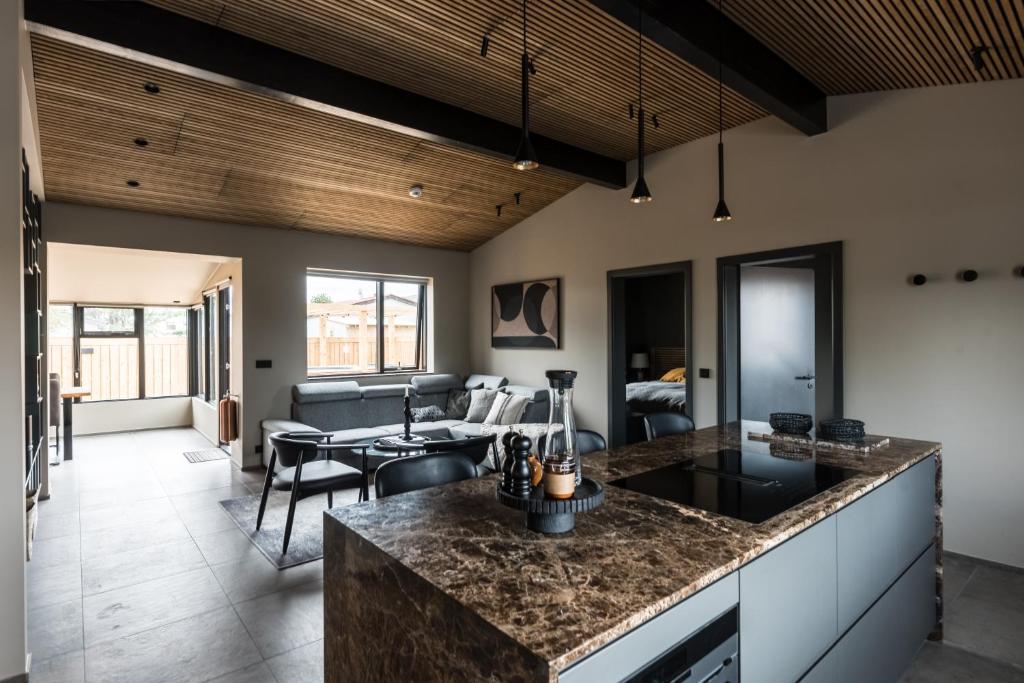 a kitchen and living room with a table and a couch at Thingvallastræti in Akureyri