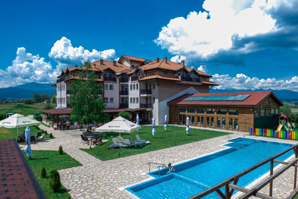um hotel com piscina em frente a um edifício em Thermal Hotel Seven Seasons em Banya