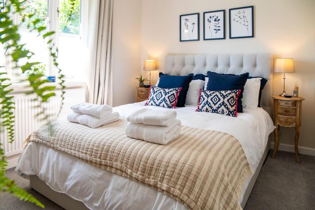 a bedroom with a white bed with pillows on it at No.51 in Lymington