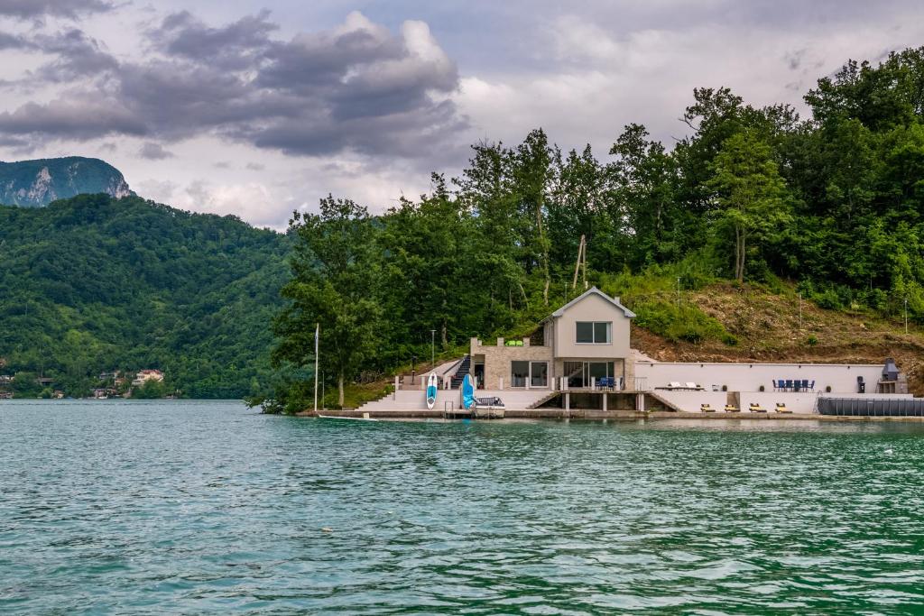 a house on a island in the middle of a lake at Happyland Villa, Jablanica in Jablanica