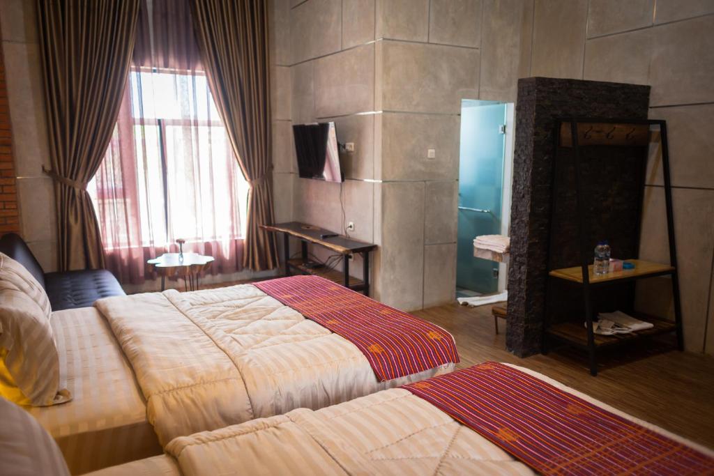 Postel nebo postele na pokoji v ubytování Pariban Hotel