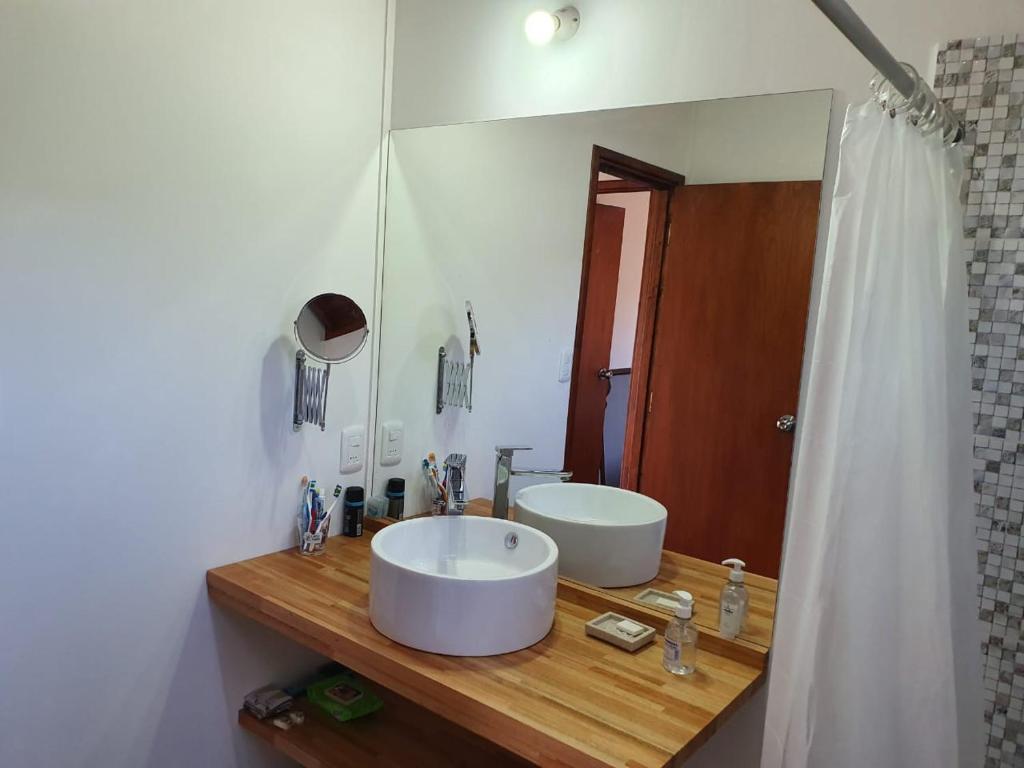 a bathroom with a sink and a large mirror at Serena in Villa Serrana