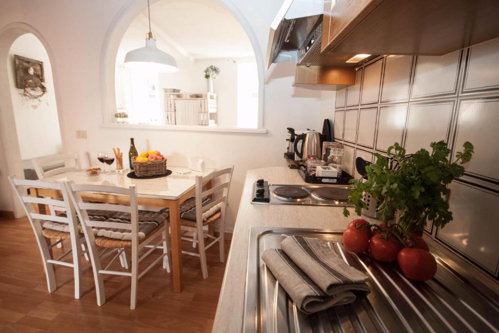 a kitchen with a table and a dining room at Menaggio Centro in Menaggio