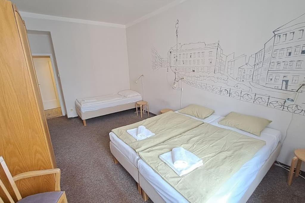 een slaapkamer met een bed met een tekening op de muur bij Comfortable apartment sleeps 6 in Praag