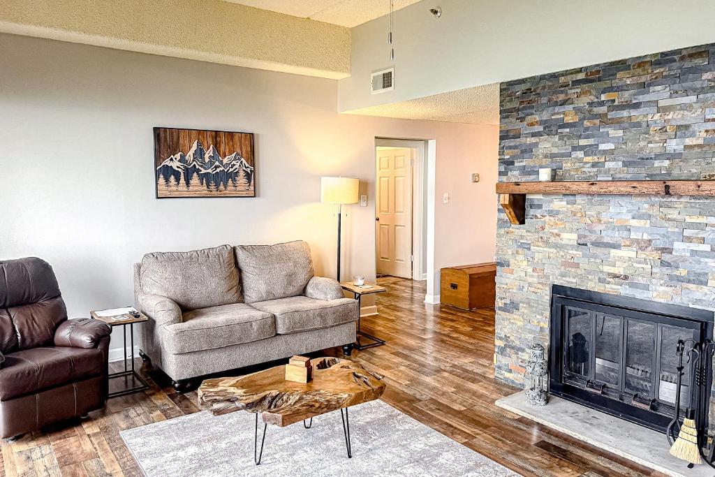 a living room with a couch and a fireplace at Grandfather View in Sugar Mountain