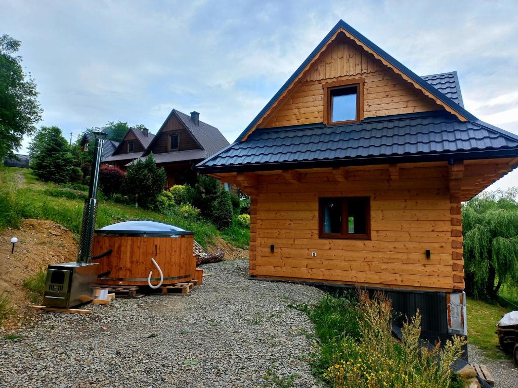 a small house with a roof on top of it at Domki Ranczo na Załpie in Laskowa