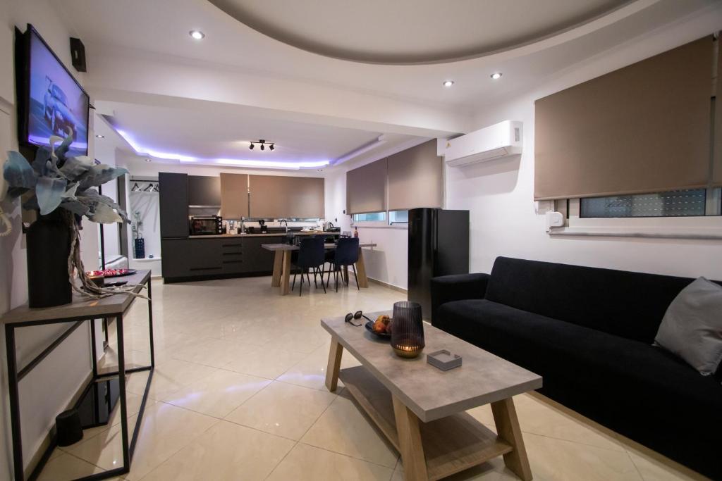 a living room with a couch and a table at Black Suites in Chania Town