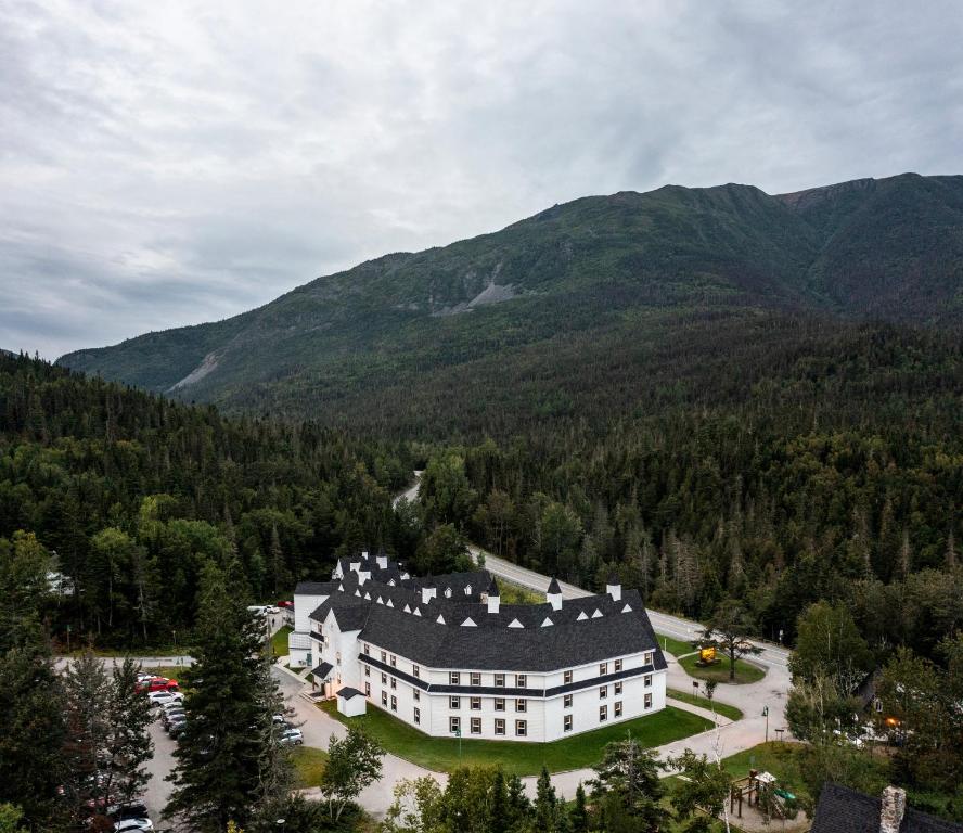 an aerial view of a large white house in the mountains at Gîte du Mont-Albert - Sepaq in Sainte-Anne-des-Monts