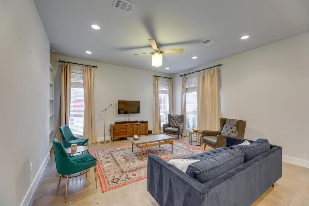 a living room with a couch and chairs and a tv at Chic Austin Vacation Rental Condo Near Downtown! in Austin