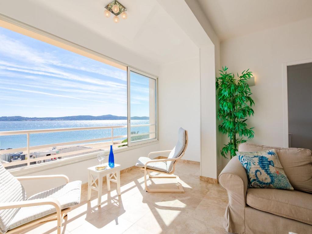 a living room with a view of the ocean at Apartment Les Dauphins-1 by Interhome in Sainte-Maxime