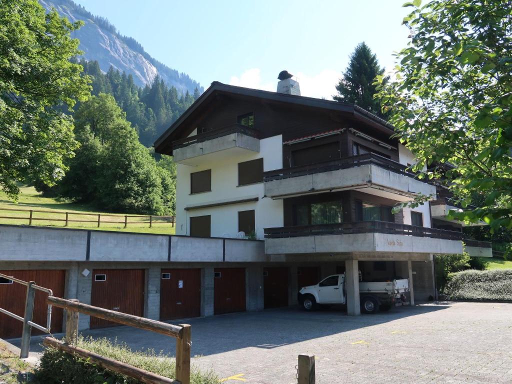 a building with a car parked in front of it at Apartment Valetta Sura by Interhome in Flims
