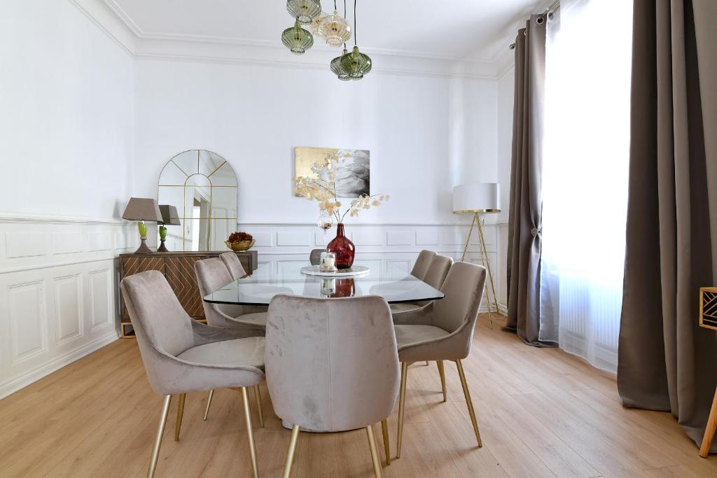 a dining room with a table and chairs at At Home in Colmar - City center in Colmar