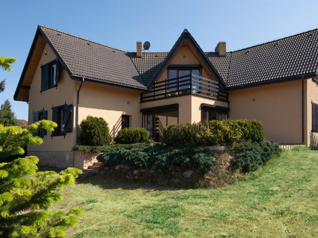 a house with a black roof and some bushes at Holiday Home Anna by Interhome in Gardna Wielka