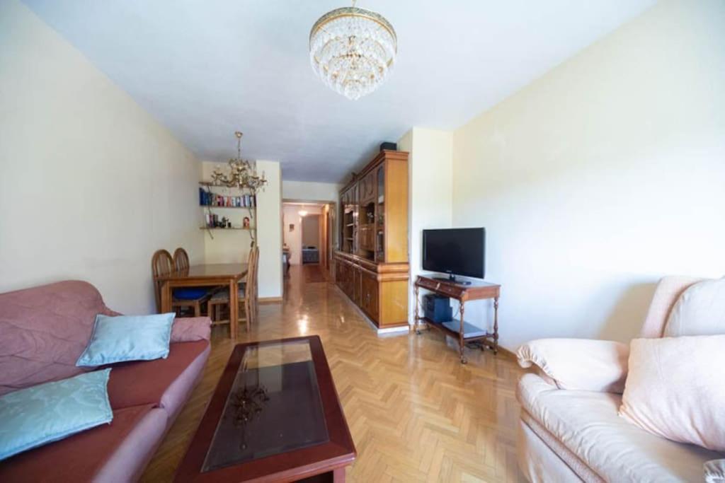 a living room with a couch and a table at Las Retamas, Alcorcón in Alcorcón