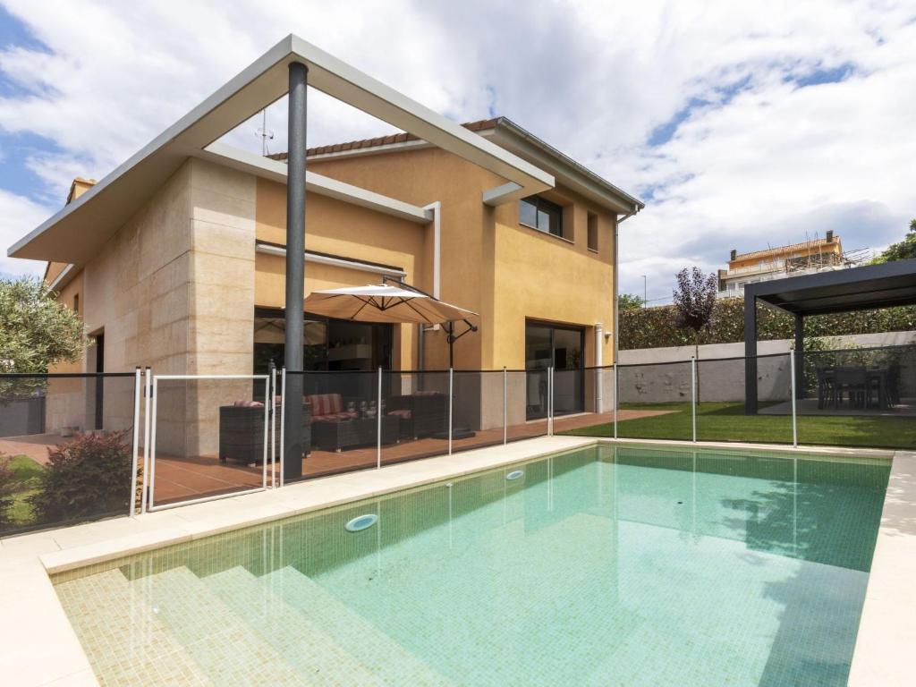 a swimming pool in front of a house at Holiday Home Volca by Interhome in Olot