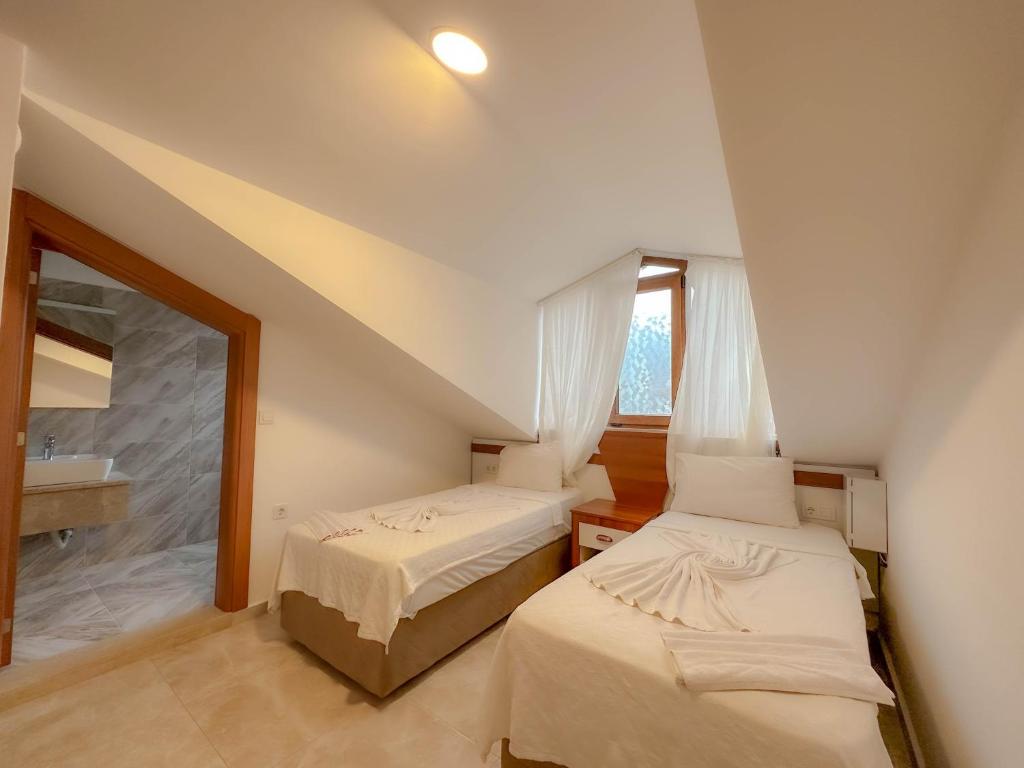 A bed or beds in a room at Tuna Fethiye Villa, Özel Havuzlu, Fethiye