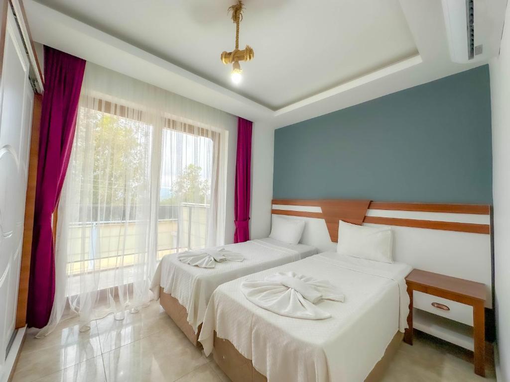 A bed or beds in a room at Tuna Fethiye Villa, Özel Havuzlu, Fethiye