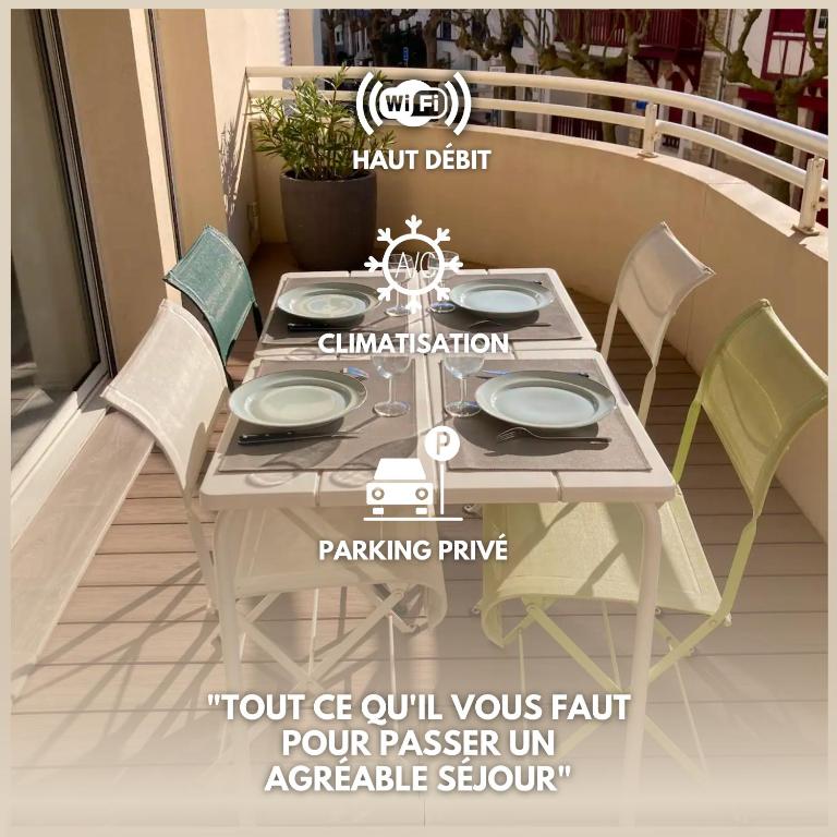 a table and chairs on a patio with at Appart Hypercentre Biarritz - PKG &#47; WIFI &#47; 4-6 Personnes in Biarritz