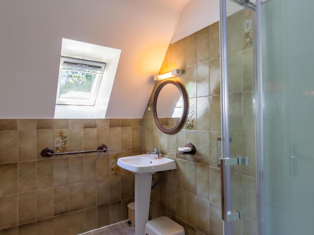 a bathroom with a sink and a shower at Holiday Home Blaue Hortensie - SZN100 by Interhome in Sizun