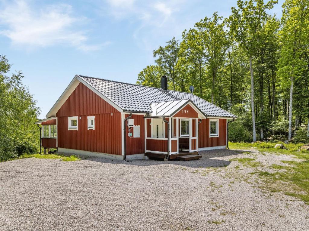 a red barn with a driveway in front at Holiday Home Erikstorp Fyran by Interhome in Olofström