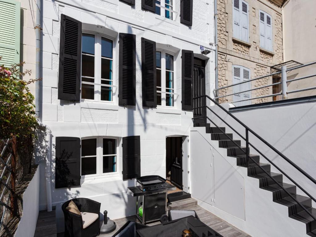 une vue extérieure d'un bâtiment avec volets noirs dans l'établissement Holiday Home Guillaume le Conquérant by Interhome, à Trouville-sur-Mer
