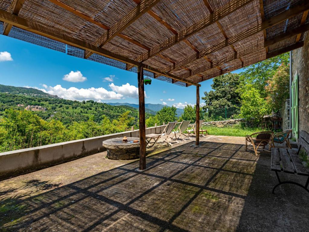 an outdoor patio with a view of the mountains at Holiday Home Penta by Interhome in Penta-di-Casinca