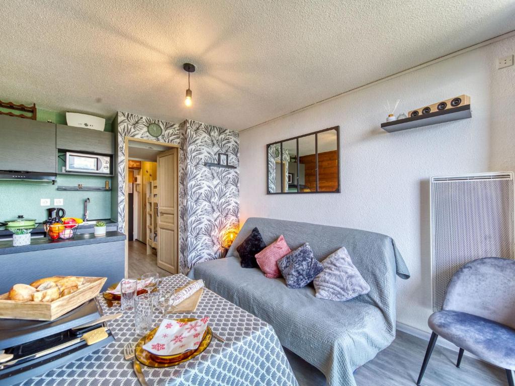 a living room with a couch and a table at Apartment Pegase Phenix-72 by Interhome in Le Corbier