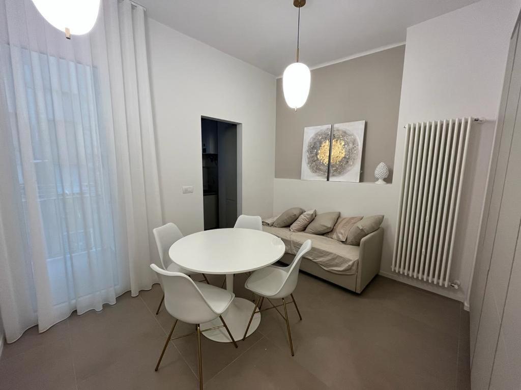 a living room with a table and chairs and a couch at URBAN SUITE in Bari