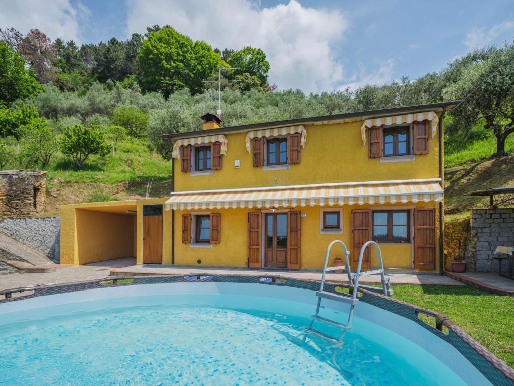 a villa with a pool in front of a house at Holiday Home Bellavista by Interhome in Strettoia