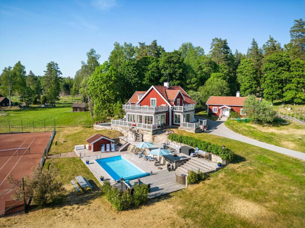 an aerial view of a large house with a swimming pool at Holiday Home Skarpsätter Sportgård by Interhome in Strängnäs