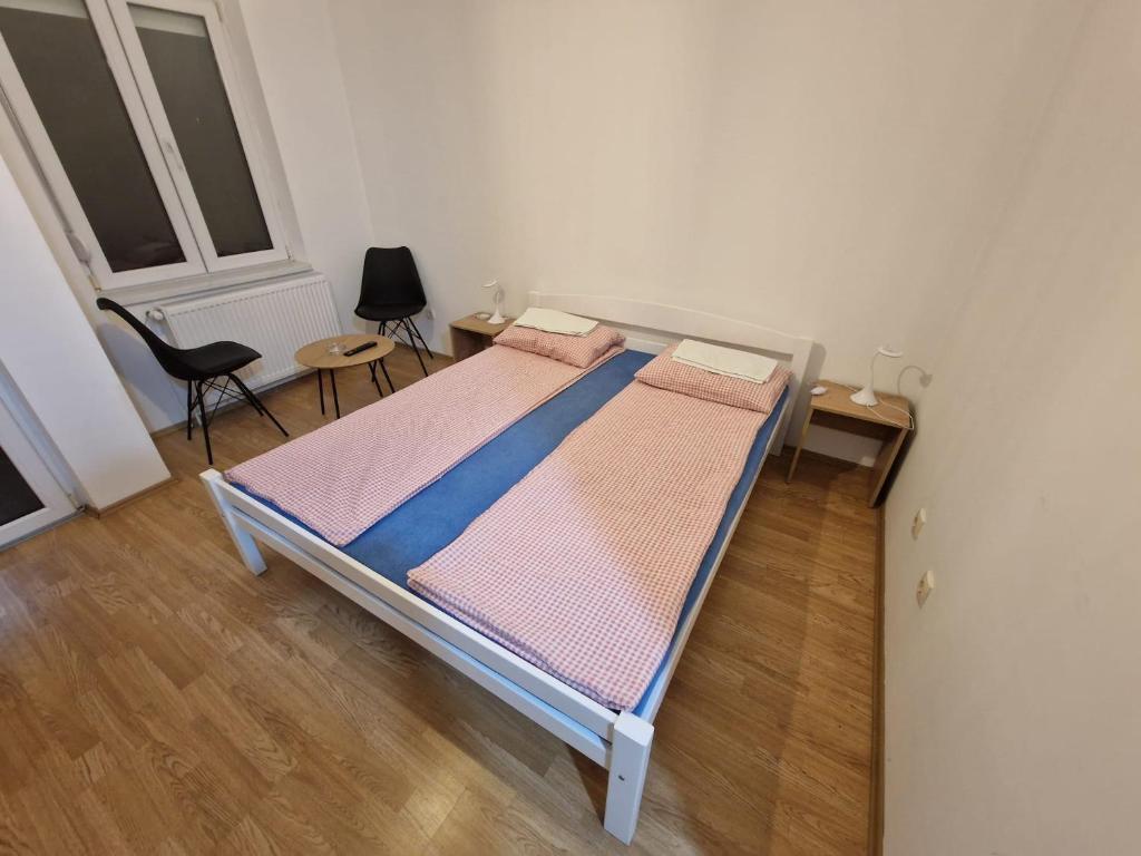 a bedroom with a bed and a chair at Sobe OLGA in Čačak