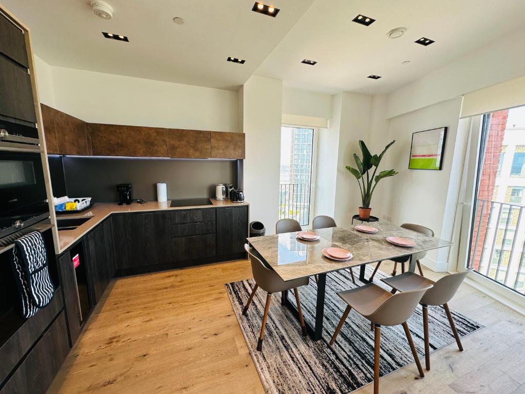 eine Küche mit einem Tisch und Stühlen im Zimmer in der Unterkunft Luxury Central Flat with Stunning Views and Pool in London