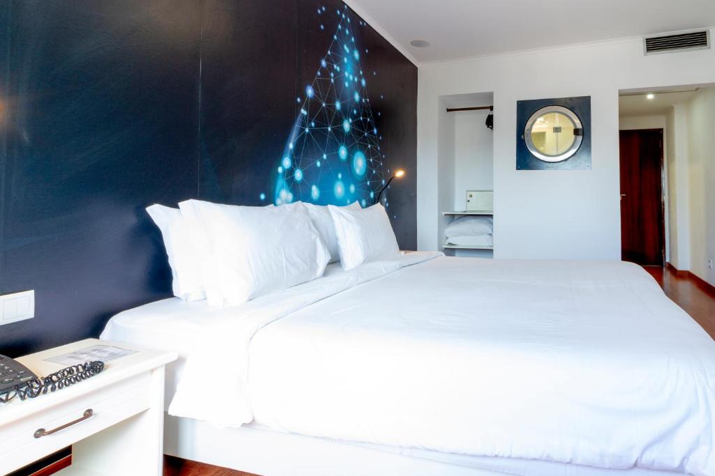 Postel nebo postele na pokoji v ubytování Hotel A.S. Lisboa