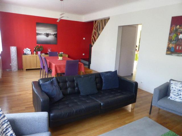 un salon avec un canapé noir et une table dans l'établissement SUPERBE VILLA - MODERNE sur JARDIN 15 Mn de Paris, à Le Perreux-Sur-Marne