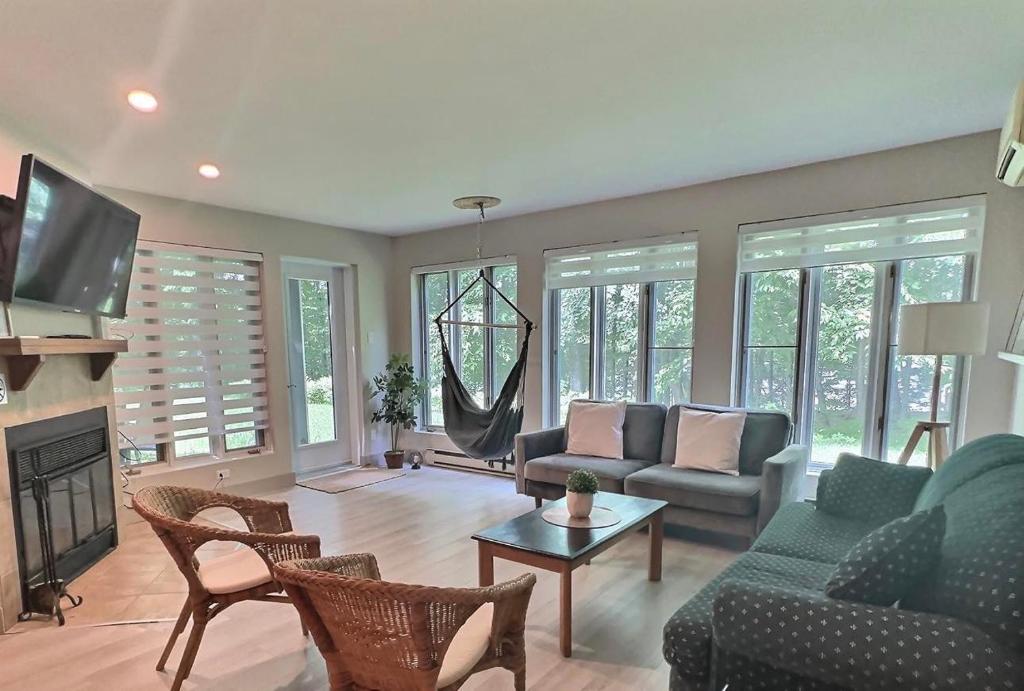 a living room with a couch and a fireplace at The Sunshine in Mont-Tremblant