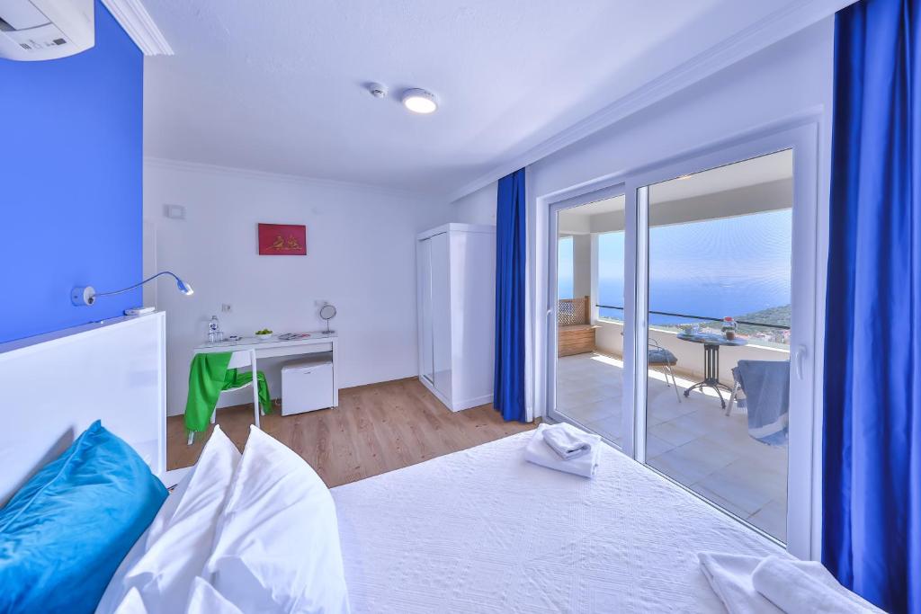 a bedroom with a bed with a view of the ocean at Elit Hotel Kas in Kaş