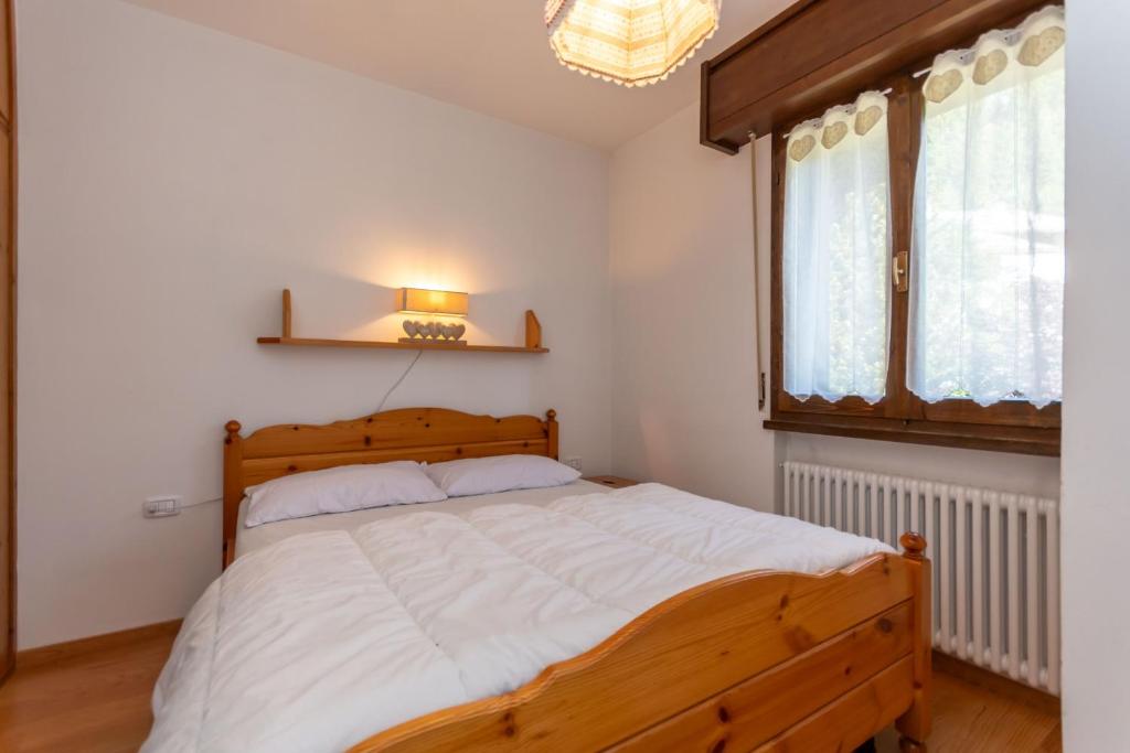 Postel nebo postele na pokoji v ubytování Residenza Latemar