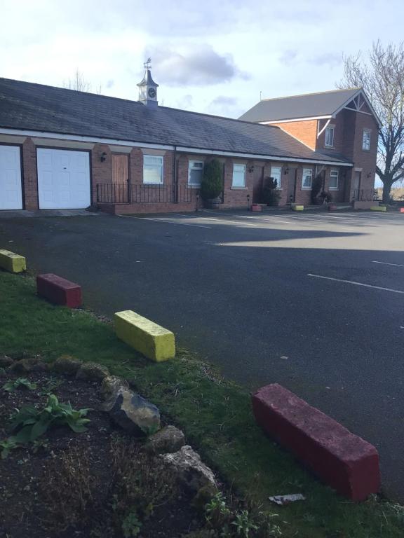 a building with a parking lot in front of a street at The Ship inn in Castle Eden