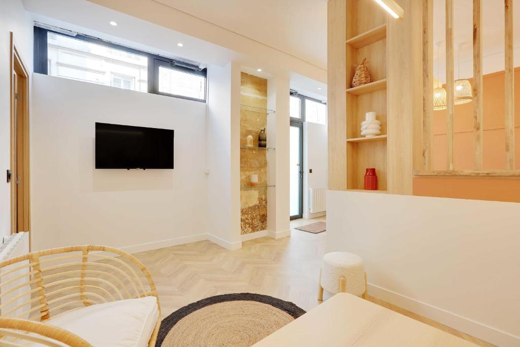 een woonkamer met een tv aan de muur bij Superb 6P apartment next to Bastille Voltaire in Parijs