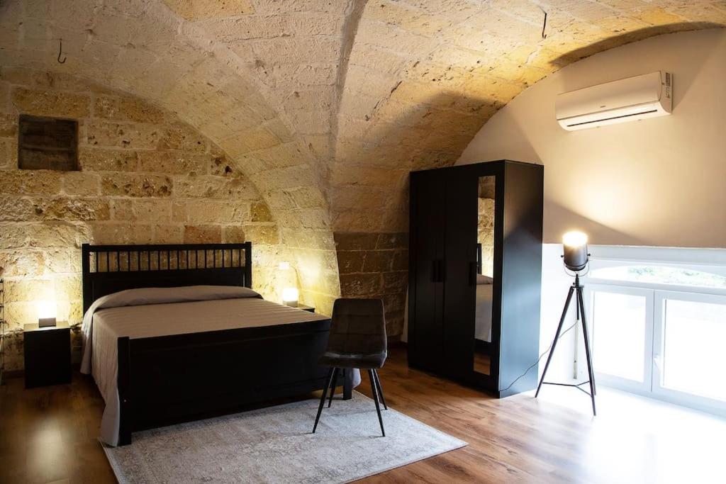 a bedroom with a bed and a tripod in a room at 24 Maggio Apartment in Galatina