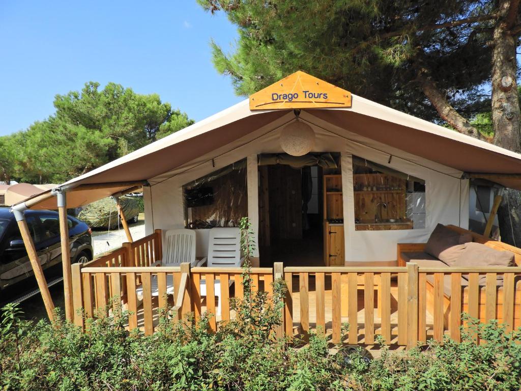 a dog house with a sign on top of it at Drago Tours LODGE TENT Holiday Deluxe, Lanterna in Poreč