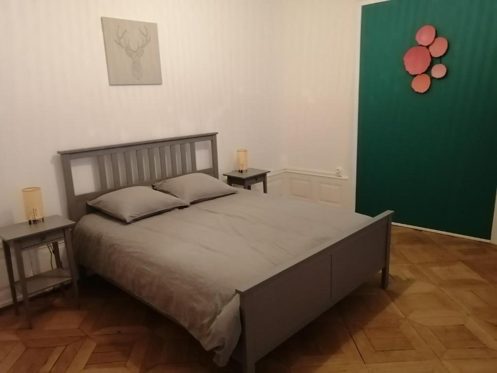 ein Schlafzimmer mit einem großen Bett mit zwei Endtischen in der Unterkunft LE 1 " GÎTES TOUT CONFORT à COLMAR CENTRE" in Colmar