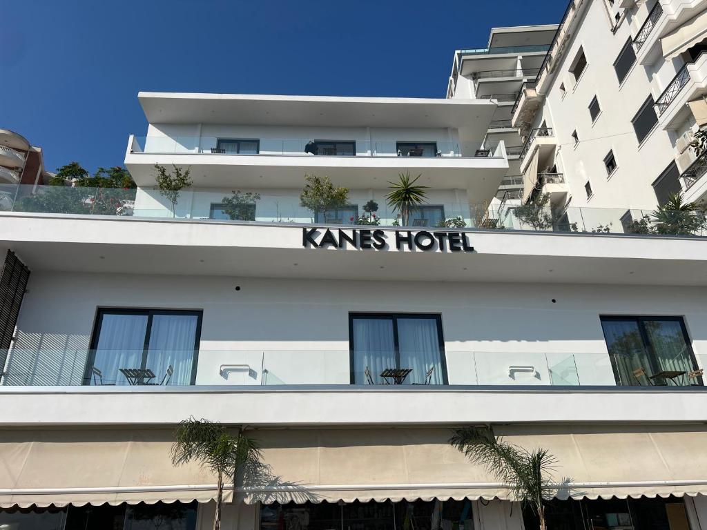 a white building with a kings hotel sign on it at Kanes Bohemian Boutique Hotel in Sarandë